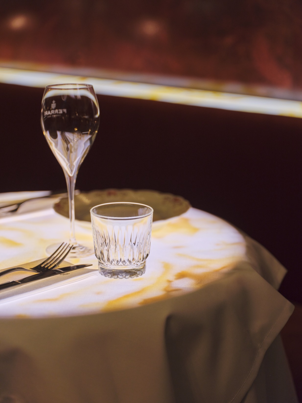 Table setting with wine glass and warm ambient light