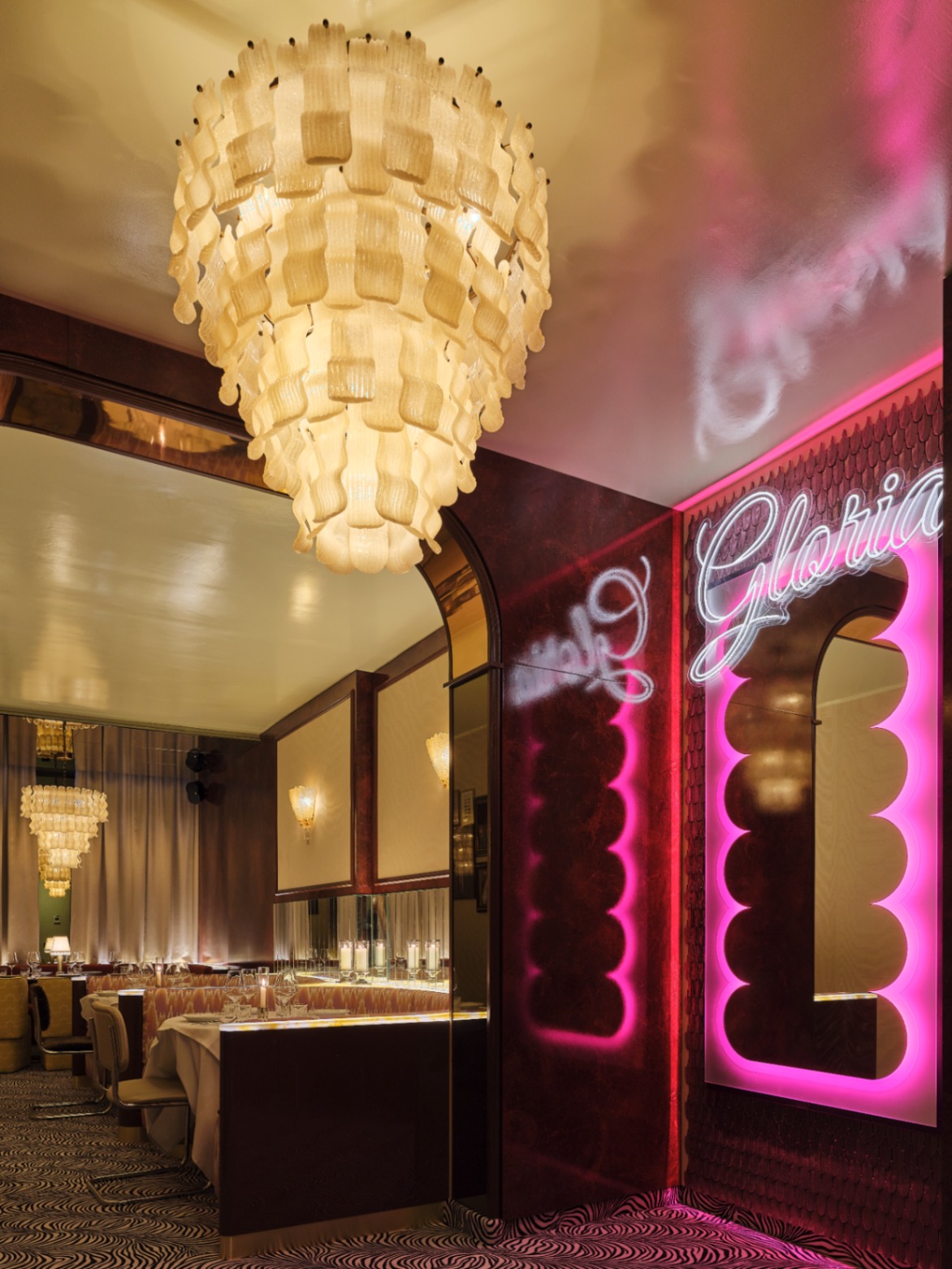 Gloria entrance with chandelier and neon signage